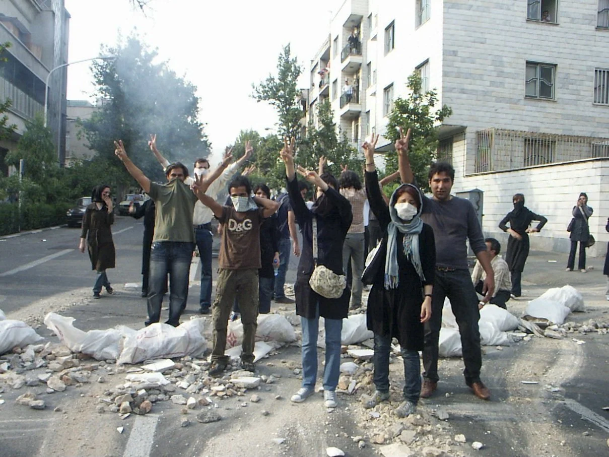 This image is part of the Green Movement documentary series, recorded during the 2009 protests in Tehran, Iran. The project documents everyday scenes and public demonstrations, reflecting resilience, collective presence, and civilian life during a si