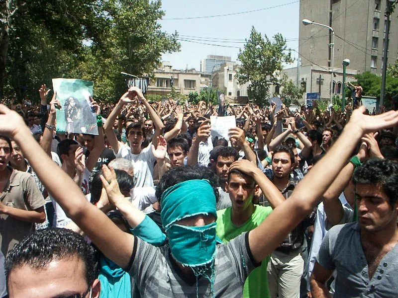 Editorial photograph from the Green Movement protests in Iran during 2009–2010, documenting public demonstrations, civic resistance, and everyday life under heightened security conditions. Part of a long-form documentary project by photographer Farha