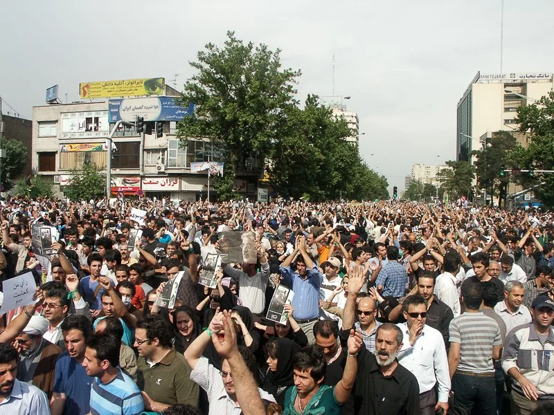 Editorial photograph from the Green Movement protests in Iran during 2009–2010, documenting public demonstrations, civic resistance, and everyday life under heightened security conditions. Part of a long-form documentary project by photographer Farha