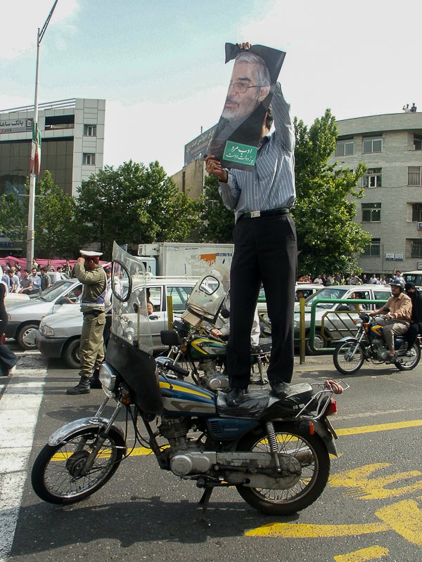 Editorial photograph from the Green Movement protests in Iran during 2009–2010, documenting public demonstrations, civic resistance, and everyday life under heightened security conditions. Part of a long-form documentary project by photographer Farha