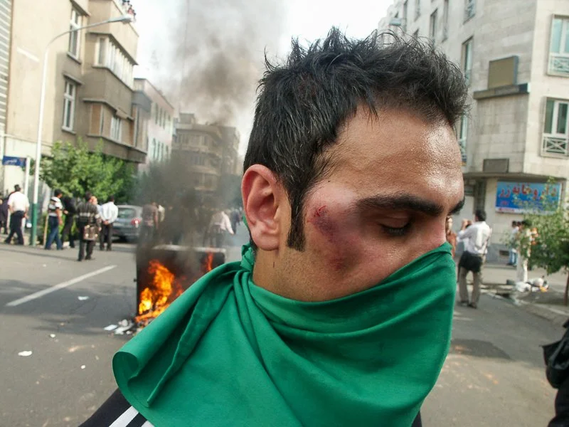 Editorial photograph from the Green Movement protests in Iran during 2009–2010, documenting public demonstrations, civic resistance, and everyday life under heightened security conditions. Part of a long-form documentary project by photographer Farha