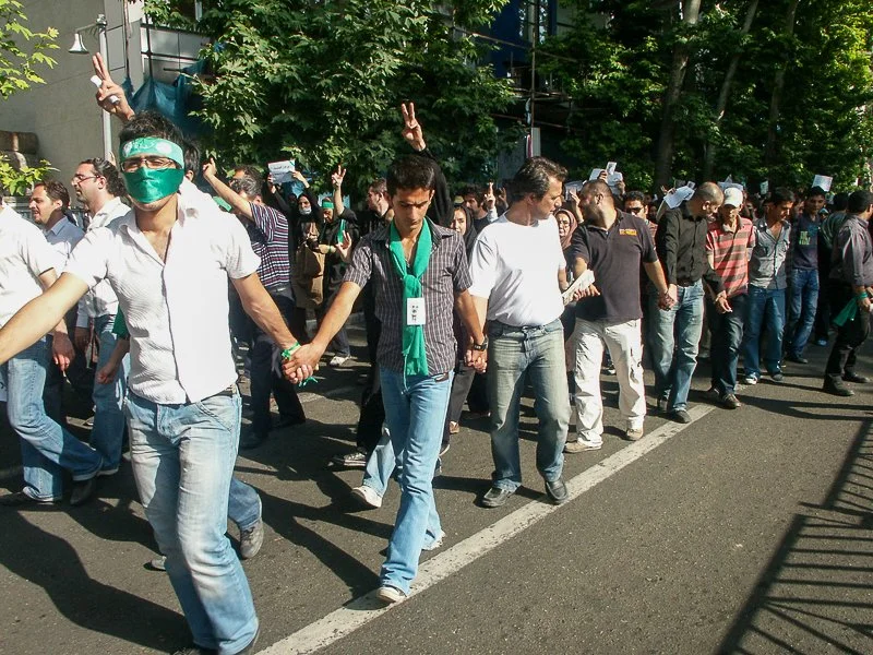Editorial photograph from the Green Movement protests in Iran during 2009–2010, documenting public demonstrations, civic resistance, and everyday life under heightened security conditions. Part of a long-form documentary project by photographer Farha