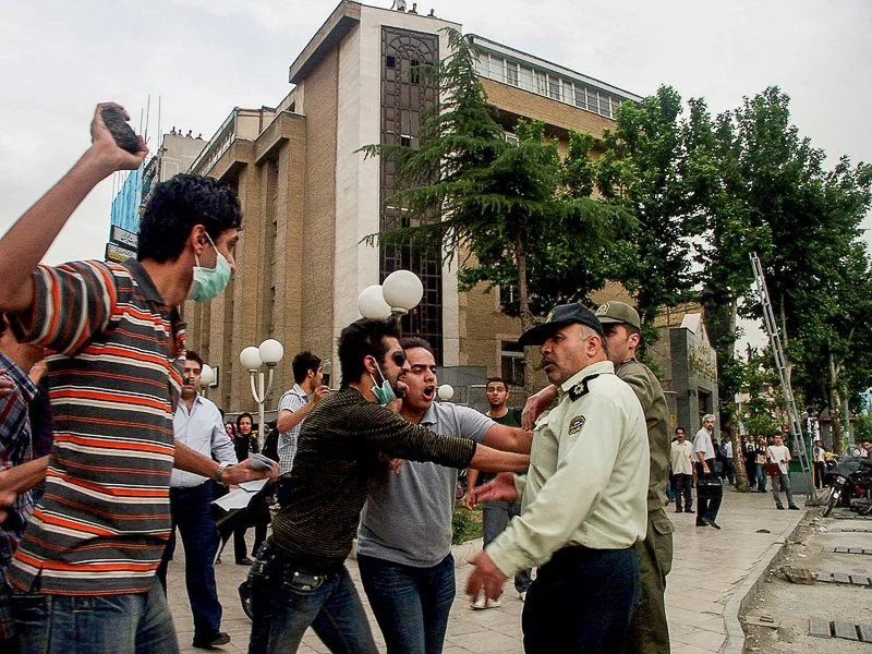 Editorial photograph from the Green Movement protests in Iran during 2009–2010, documenting public demonstrations, civic resistance, and everyday life under heightened security conditions. Part of a long-form documentary project by photographer Farha