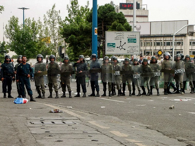 Editorial photograph from the Green Movement protests in Iran during 2009–2010, documenting public demonstrations, civic resistance, and everyday life under heightened security conditions. Part of a long-form documentary project by photographer Farha