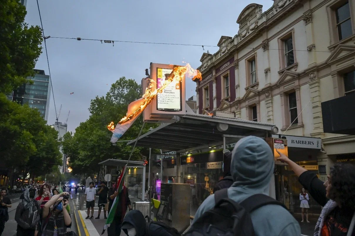 Documentary photograph from a pro-Palestine march through Melbourne’s CBD, capturing public protest, political expression, and street-level moments.
Photo by Farhad Rajabali | Artssie