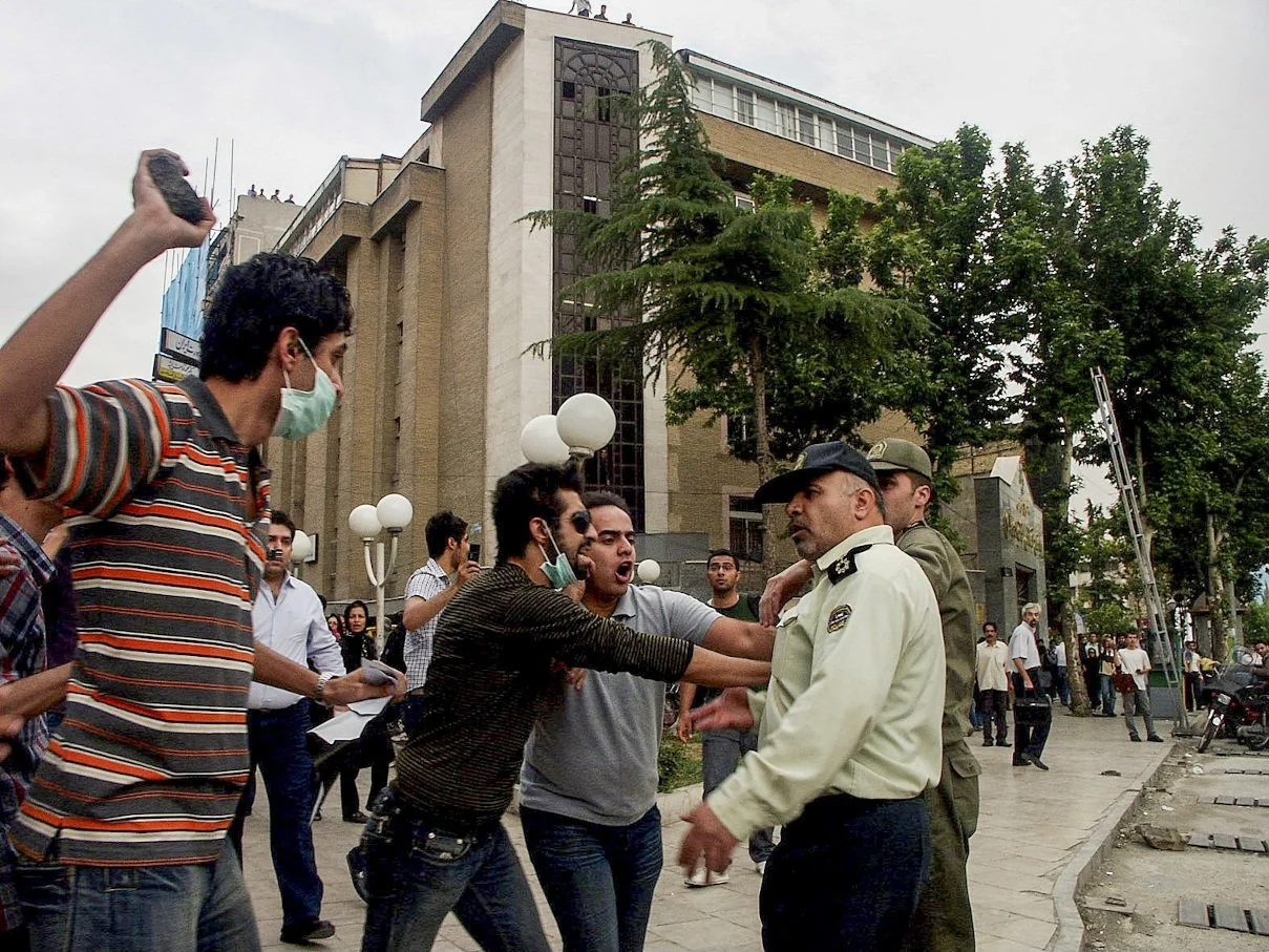This image is part of the Green Movement documentary series, recorded during the 2009 protests in Tehran, Iran. The project documents everyday scenes and public demonstrations, reflecting resilience, collective presence, and civilian life during a si