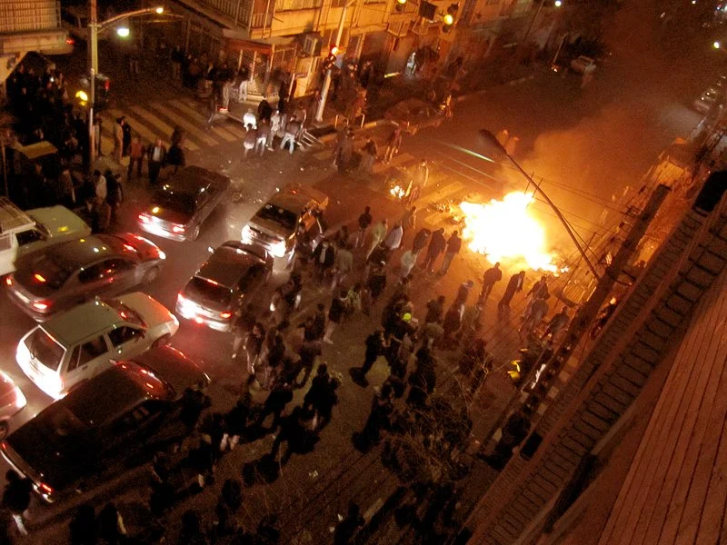 Editorial photograph from the Green Movement protests in Iran during 2009–2010, documenting public demonstrations, civic resistance, and everyday life under heightened security conditions. Part of a long-form documentary project by photographer Farha