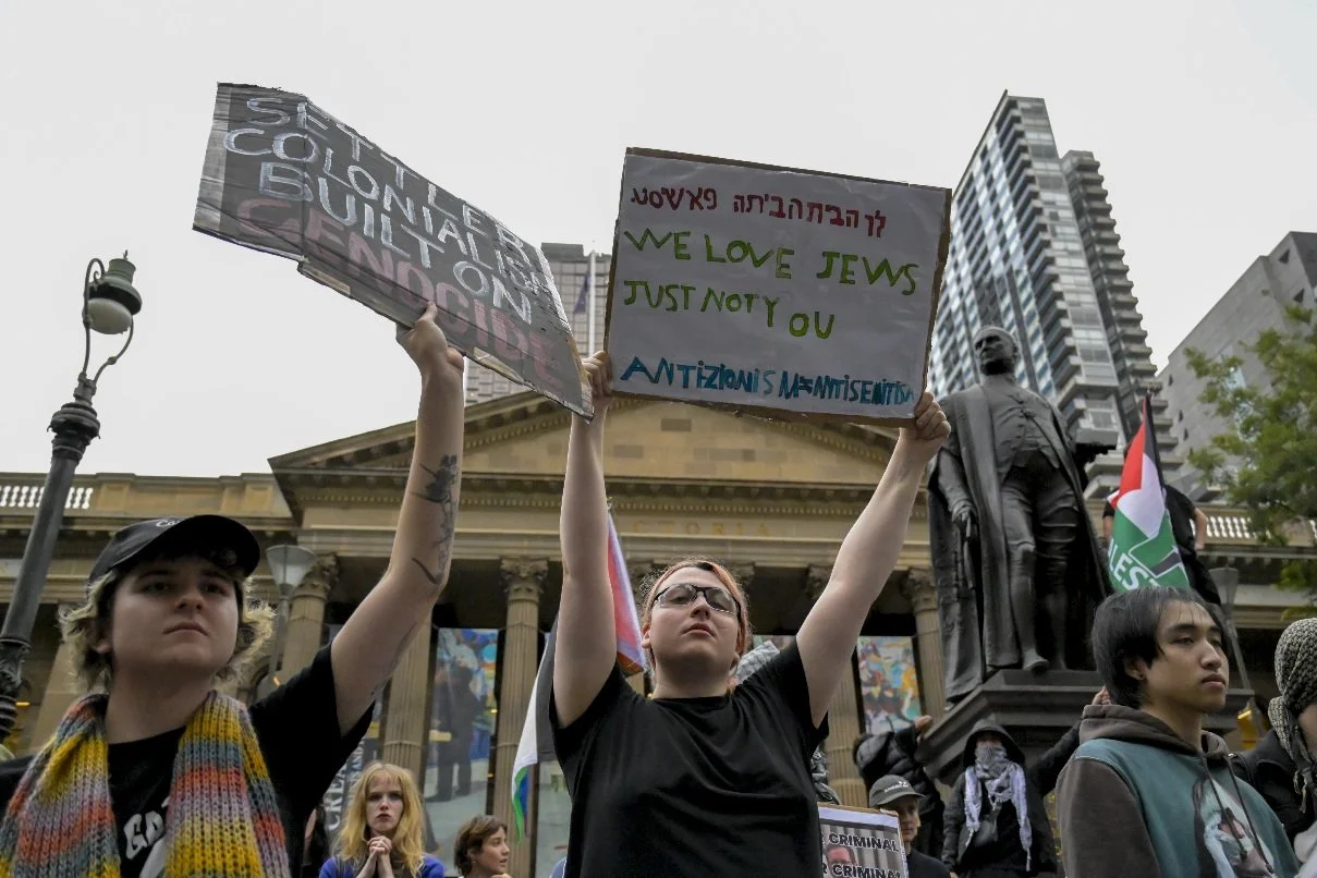 This documentary photograph was taken during a pro-Palestine march through Melbourne’s CBD, showing public protest, political symbolism, and everyday human moments within an urban demonstration. Photo by Farhad Rajabali