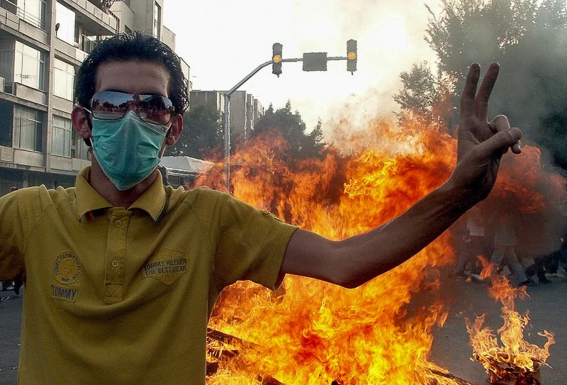 Editorial photograph from the Green Movement protests in Iran during 2009–2010, documenting public demonstrations, civic resistance, and everyday life under heightened security conditions. Part of a long-form documentary project by photographer Farha