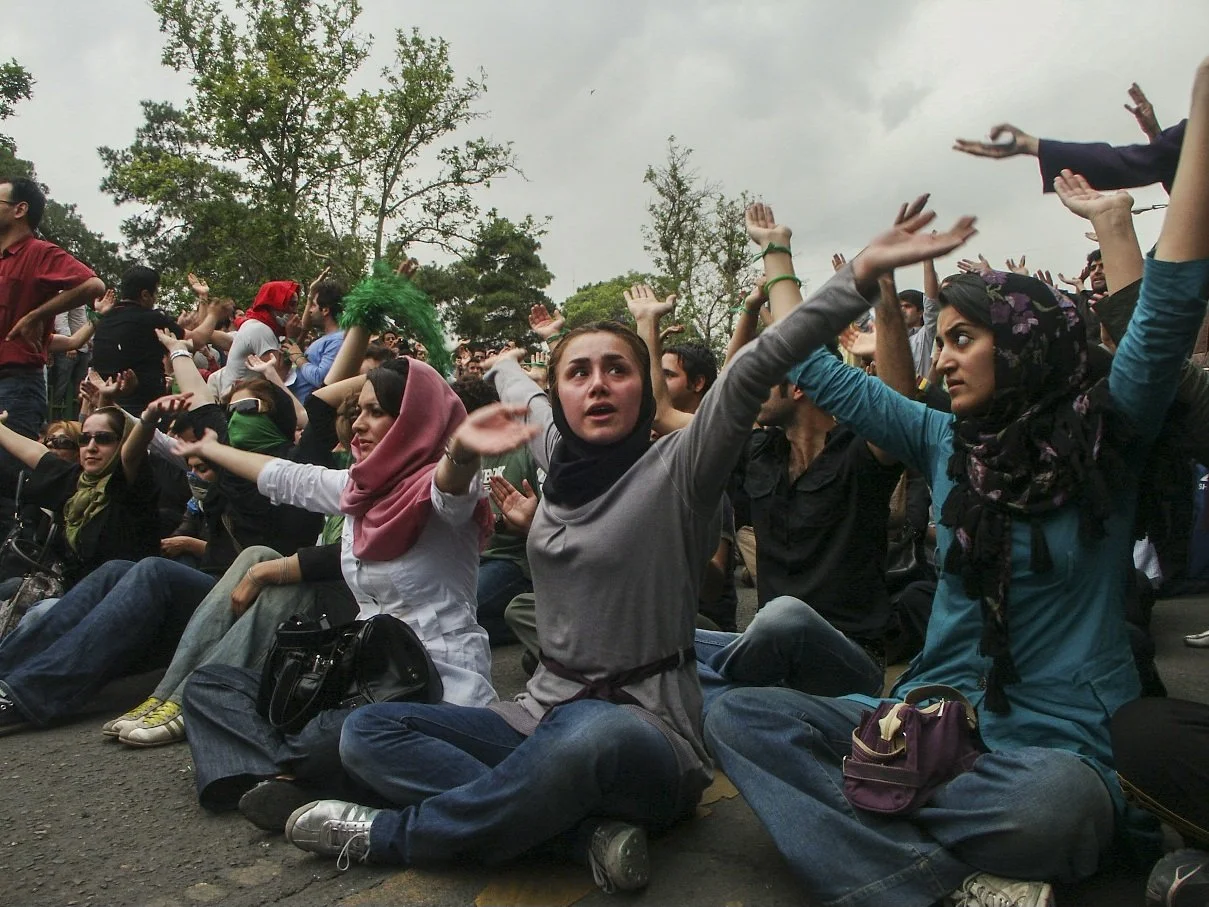 This image is part of the Green Movement documentary series, recorded during the 2009 protests in Tehran, Iran. The project documents everyday scenes and public demonstrations, reflecting resilience, collective presence, and civilian life during a si