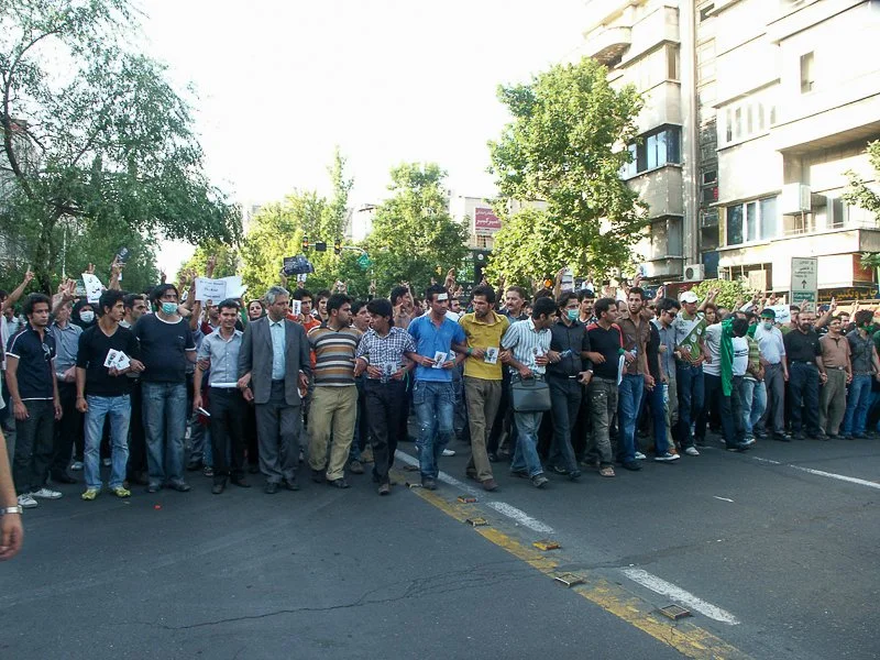 Editorial photograph from the Green Movement protests in Iran during 2009–2010, documenting public demonstrations, civic resistance, and everyday life under heightened security conditions. Part of a long-form documentary project by photographer Farha