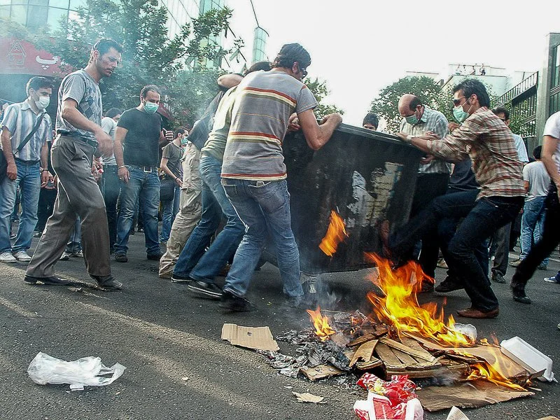 Editorial photograph from the Green Movement protests in Iran during 2009–2010, documenting public demonstrations, civic resistance, and everyday life under heightened security conditions. Part of a long-form documentary project by photographer Farha