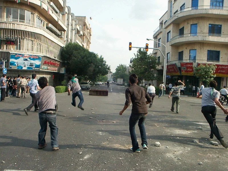 Editorial photograph from the Green Movement protests in Iran during 2009–2010, documenting public demonstrations, civic resistance, and everyday life under heightened security conditions. Part of a long-form documentary project by photographer Farha