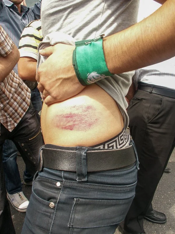 Editorial photograph from the Green Movement protests in Iran during 2009–2010, documenting public demonstrations, civic resistance, and everyday life under heightened security conditions. Part of a long-form documentary project by photographer Farha