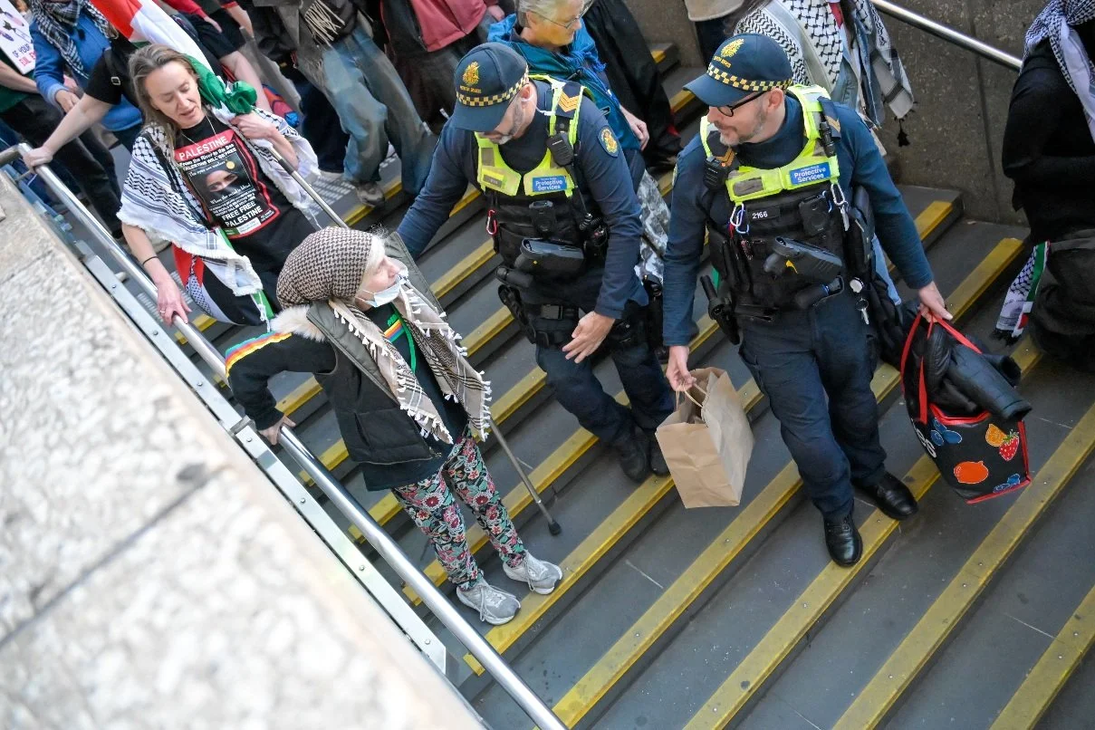 Documentary photograph taken during the Israeli President’s visit to Melbourne on 12 February, capturing protests in Southbank and the CBD, police security measures, and street-level tensions. | photo by Farhad Rajabali