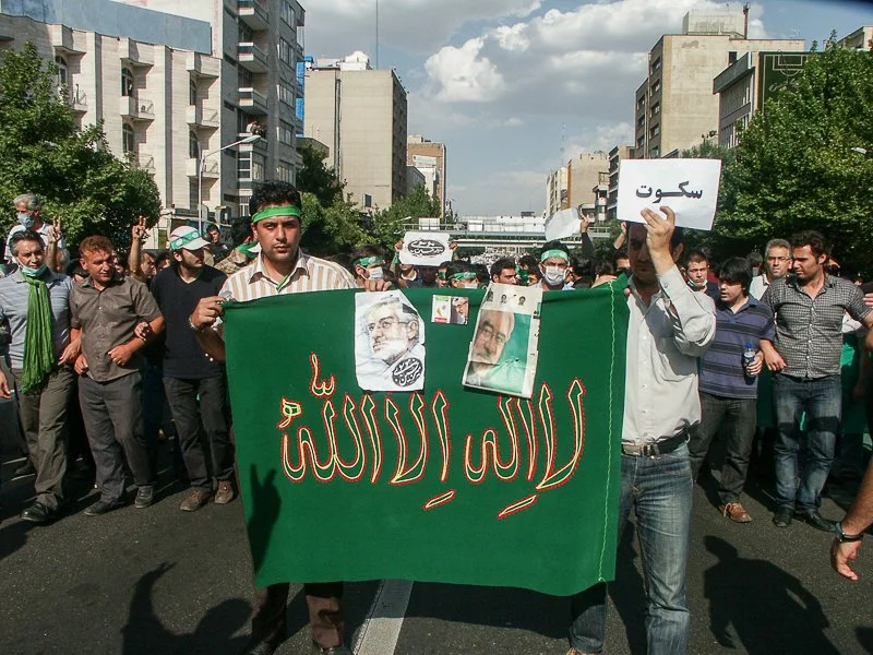 Editorial photograph from the Green Movement protests in Iran during 2009–2010, documenting public demonstrations, civic resistance, and everyday life under heightened security conditions. Part of a long-form documentary project by photographer Farha
