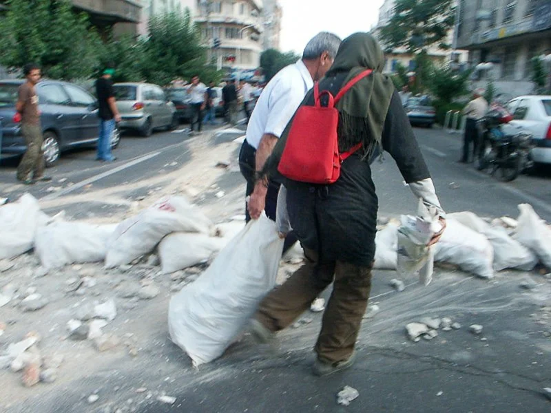 Editorial photograph from the Green Movement protests in Iran during 2009–2010, documenting public demonstrations, civic resistance, and everyday life under heightened security conditions. Part of a long-form documentary project by photographer Farha