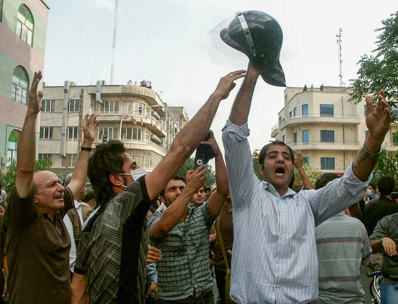 Editorial photograph from the Green Movement protests in Iran during 2009–2010, documenting public demonstrations, civic resistance, and everyday life under heightened security conditions. Part of a long-form documentary project by photographer Farha
