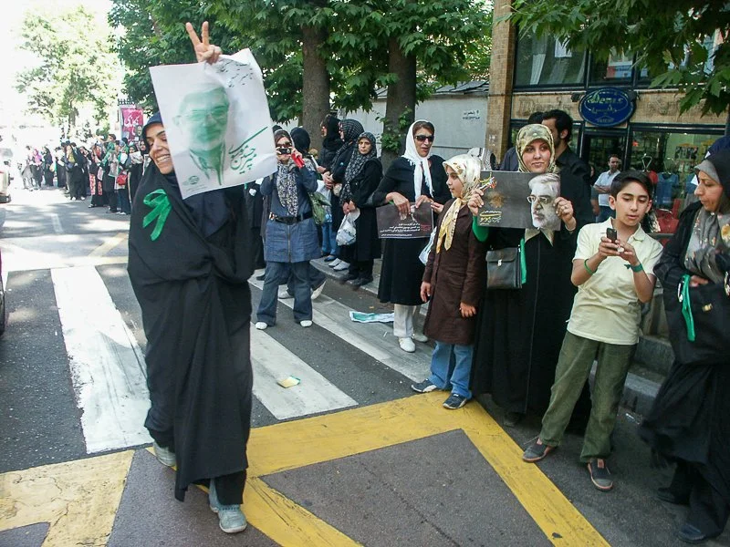 Editorial photograph from the Green Movement protests in Iran during 2009–2010, documenting public demonstrations, civic resistance, and everyday life under heightened security conditions. Part of a long-form documentary project by photographer Farha