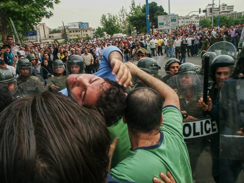 Editorial photograph from the Green Movement protests in Iran during 2009–2010, documenting public demonstrations, civic resistance, and everyday life under heightened security conditions. Part of a long-form documentary project by photographer Farha