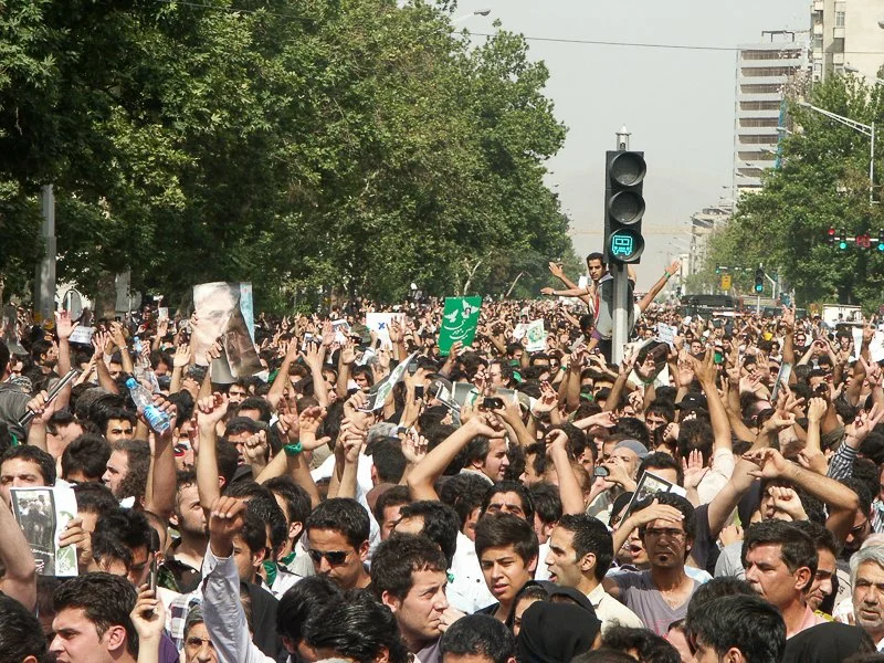 Editorial photograph from the Green Movement protests in Iran during 2009–2010, documenting public demonstrations, civic resistance, and everyday life under heightened security conditions. Part of a long-form documentary project by photographer Farha