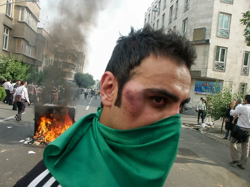 Editorial photograph from the Green Movement protests in Iran during 2009–2010, documenting public demonstrations, civic resistance, and everyday life under heightened security conditions. Part of a long-form documentary project by photographer Farha