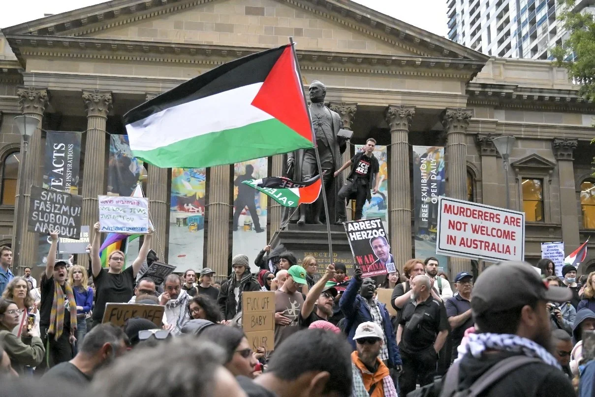 Documentary photograph from a pro-Palestine march through Melbourne’s CBD, capturing public protest, political expression, and street-level moments.
Photo by Farhad Rajabali | Artssie