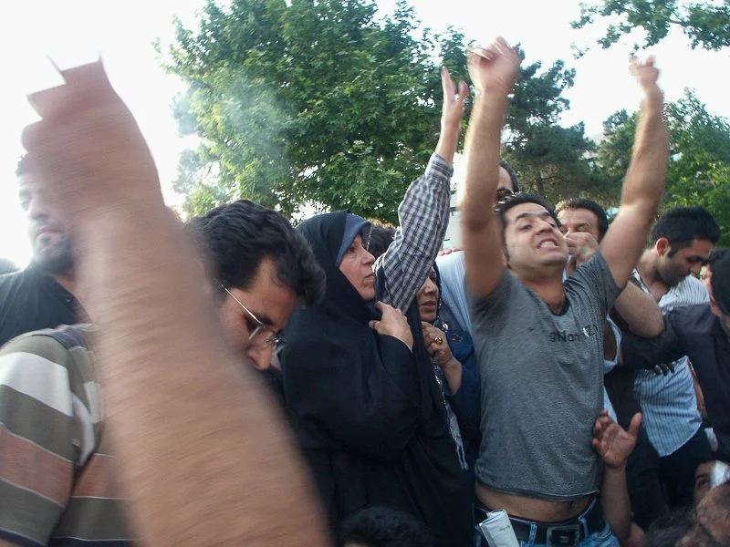 Editorial photograph from the Green Movement protests in Iran during 2009–2010, documenting public demonstrations, civic resistance, and everyday life under heightened security conditions. Part of a long-form documentary project by photographer Farha
