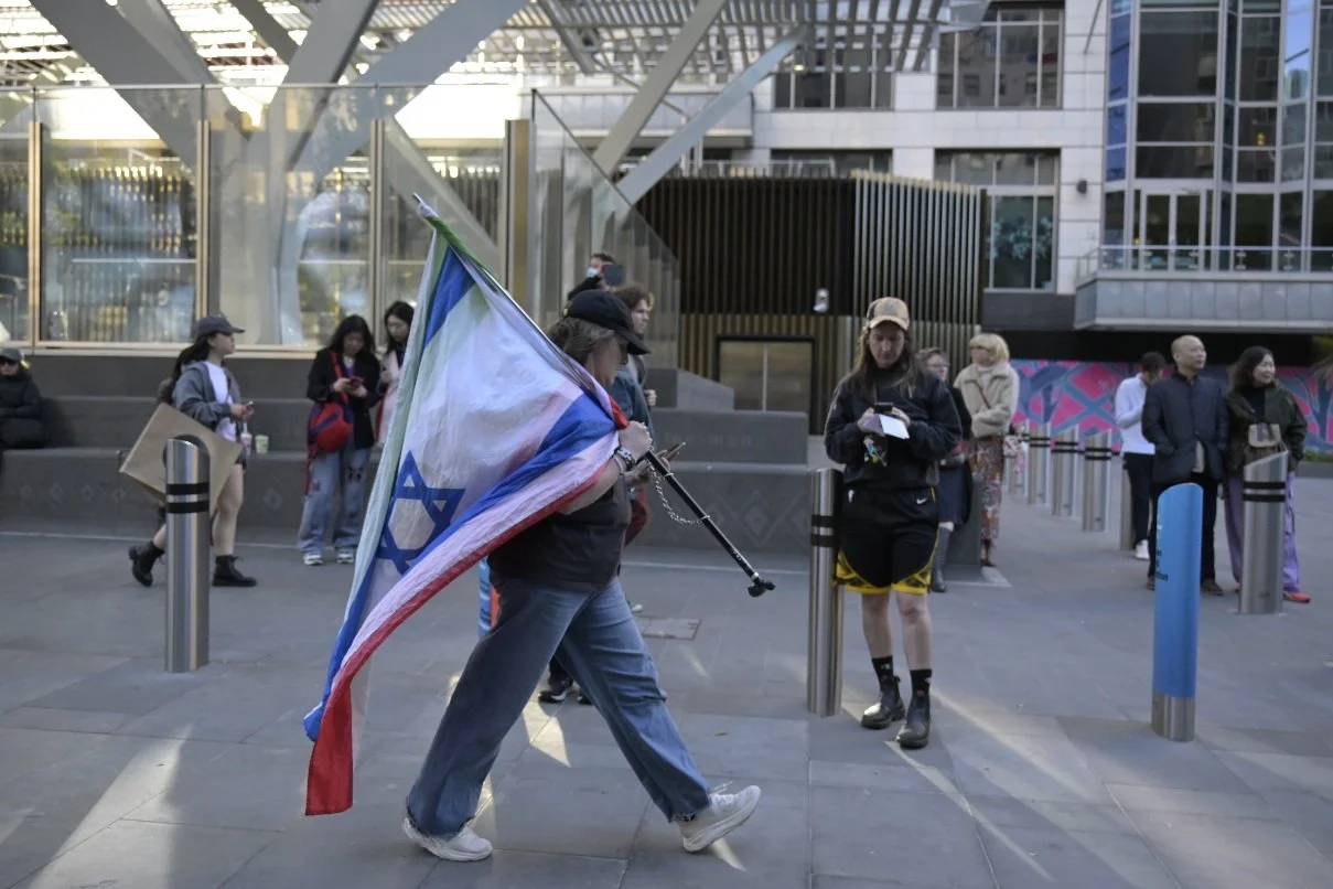 Documentary photograph taken during the Israeli President’s visit to Melbourne on 12 February, capturing protests in Southbank and the CBD, police security measures, and street-level tensions. | photo by Farhad Rajabali
