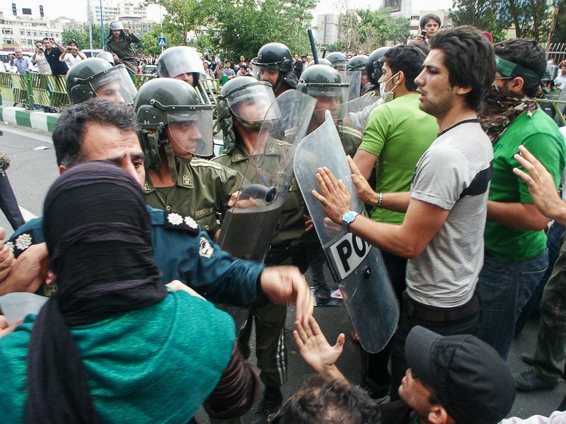 Editorial photograph from the Green Movement protests in Iran during 2009–2010, documenting public demonstrations, civic resistance, and everyday life under heightened security conditions. Part of a long-form documentary project by photographer Farha