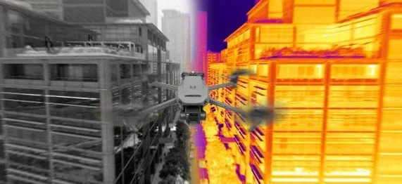 A train traveling between a gray-colored railway track on the left and bright orange and yellow buildings on the right, with some pink and purple structures in the background.