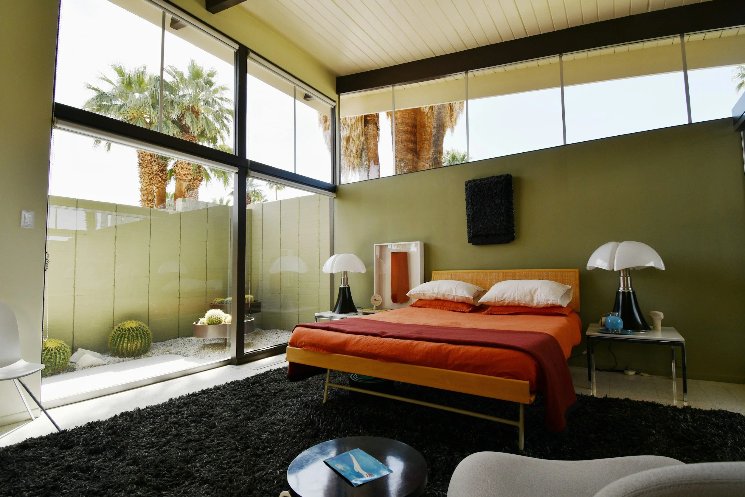 Mid-century modern bedroom in a Palm Springs short-term rental managed by Staylocal — boutique vacation rental management with 9,200+ five-star reviews.

