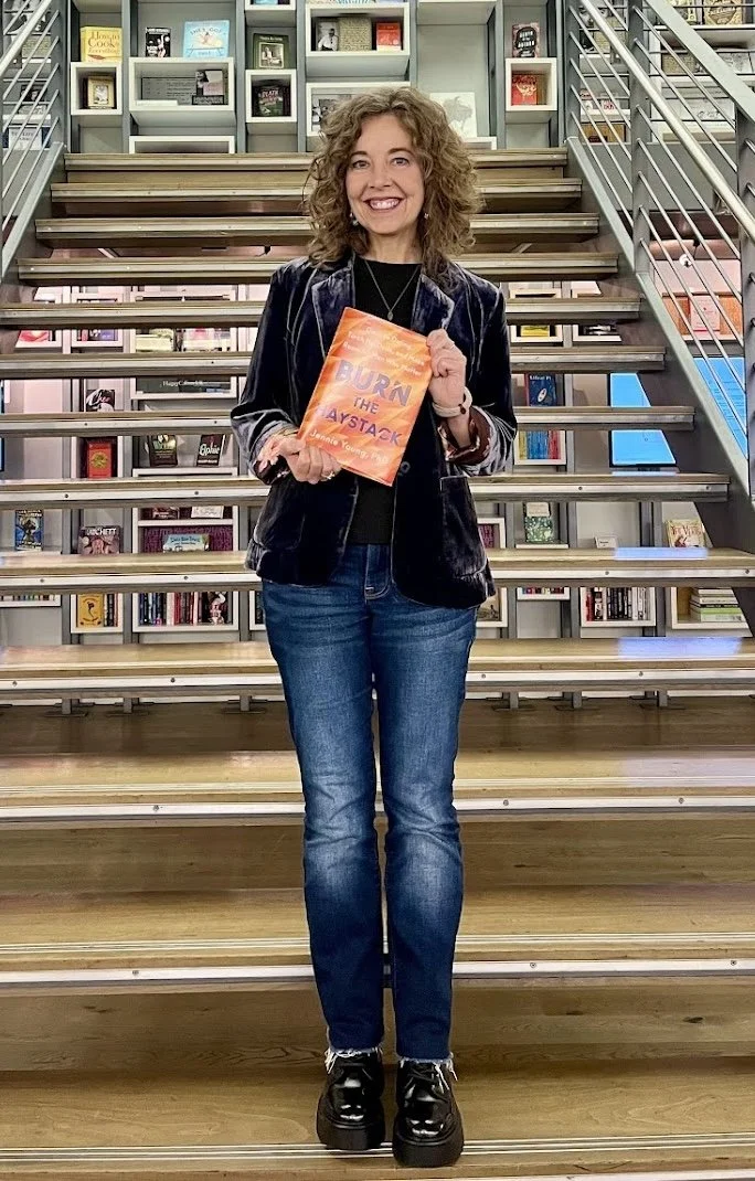 Jennie Young holding her book Burn the Haystack