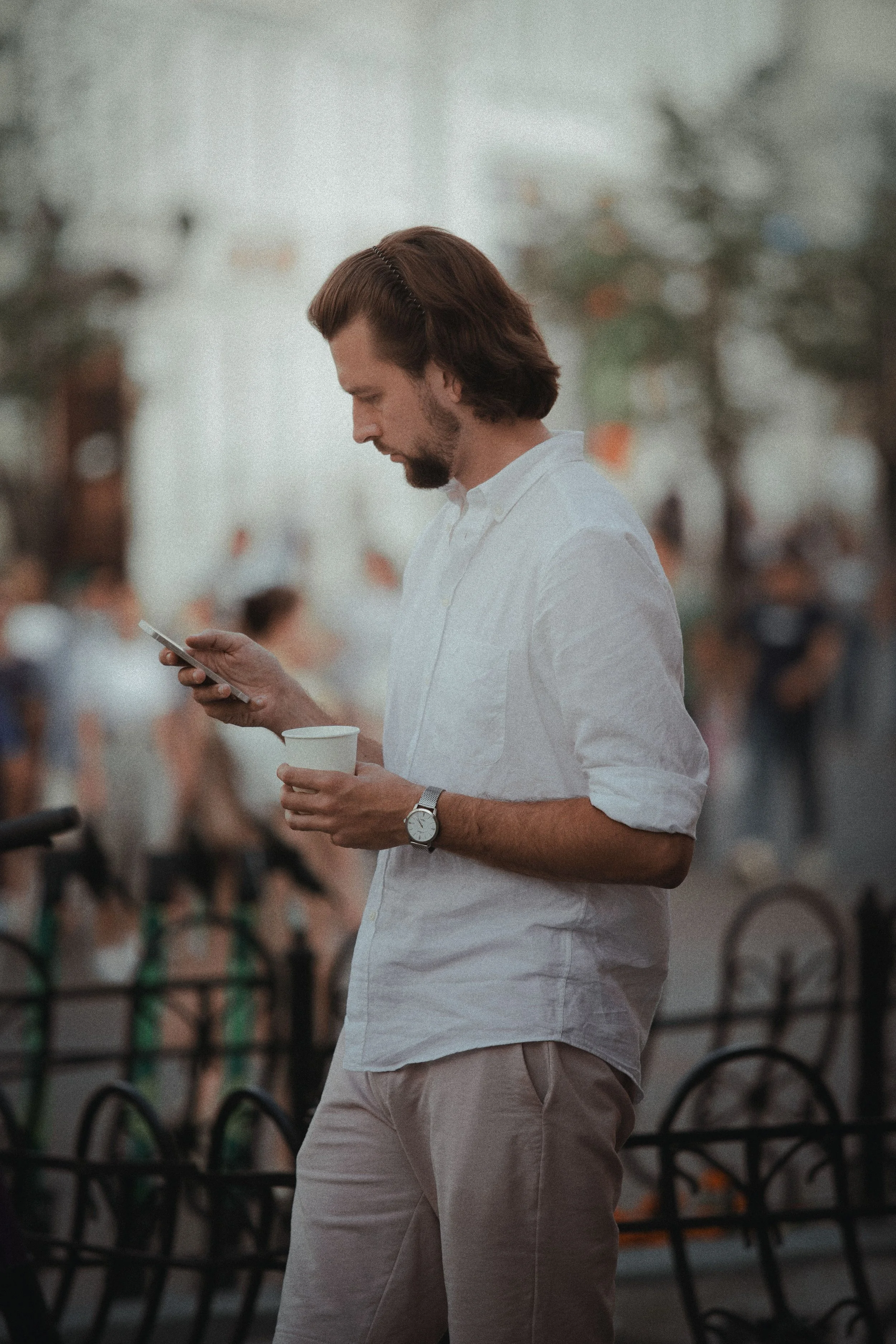 Man checking his phone on a coffee break, OCD therapy for Connecticut professionals
