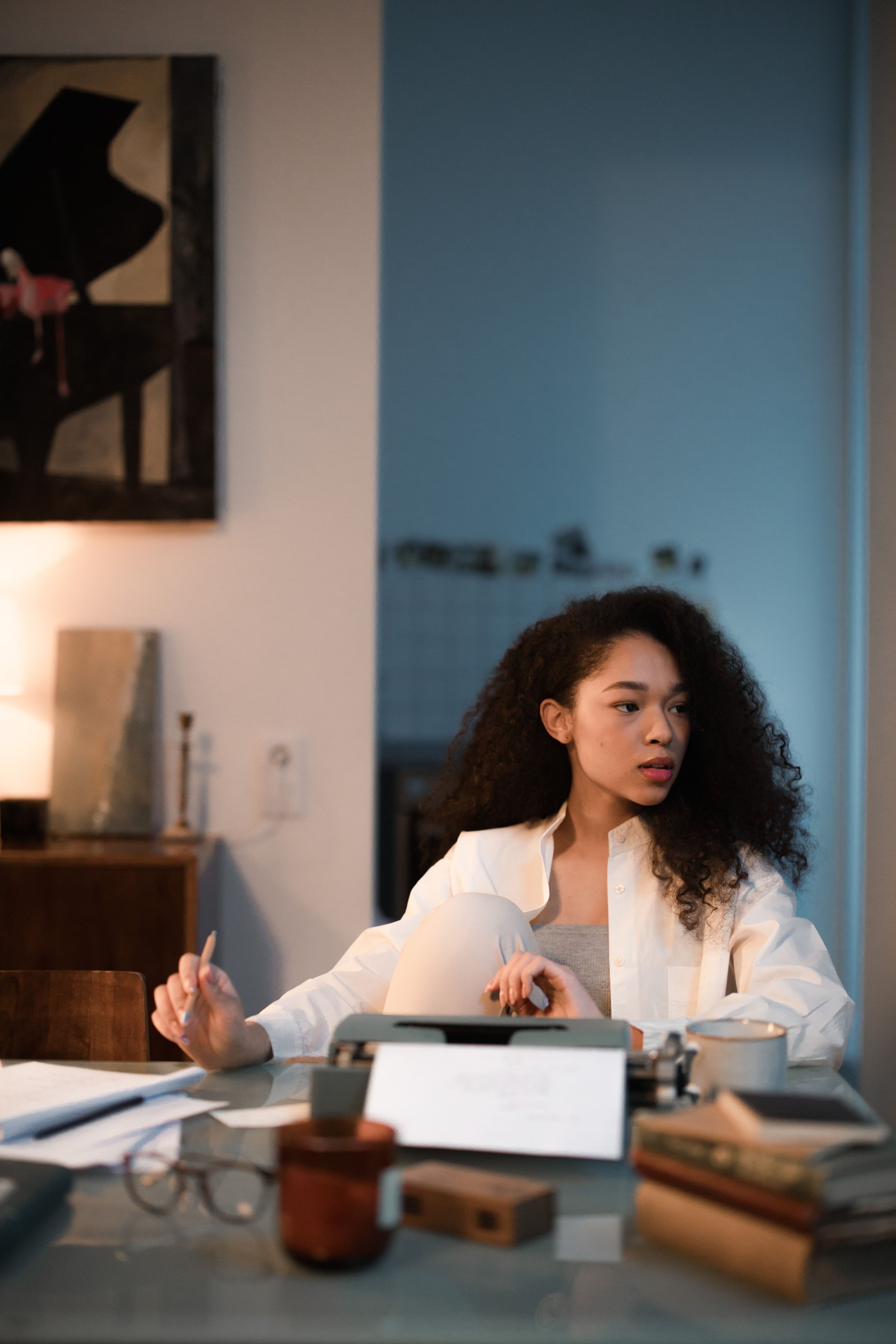 Woman at her desk in quiet thought, representing OCD therapy in New York