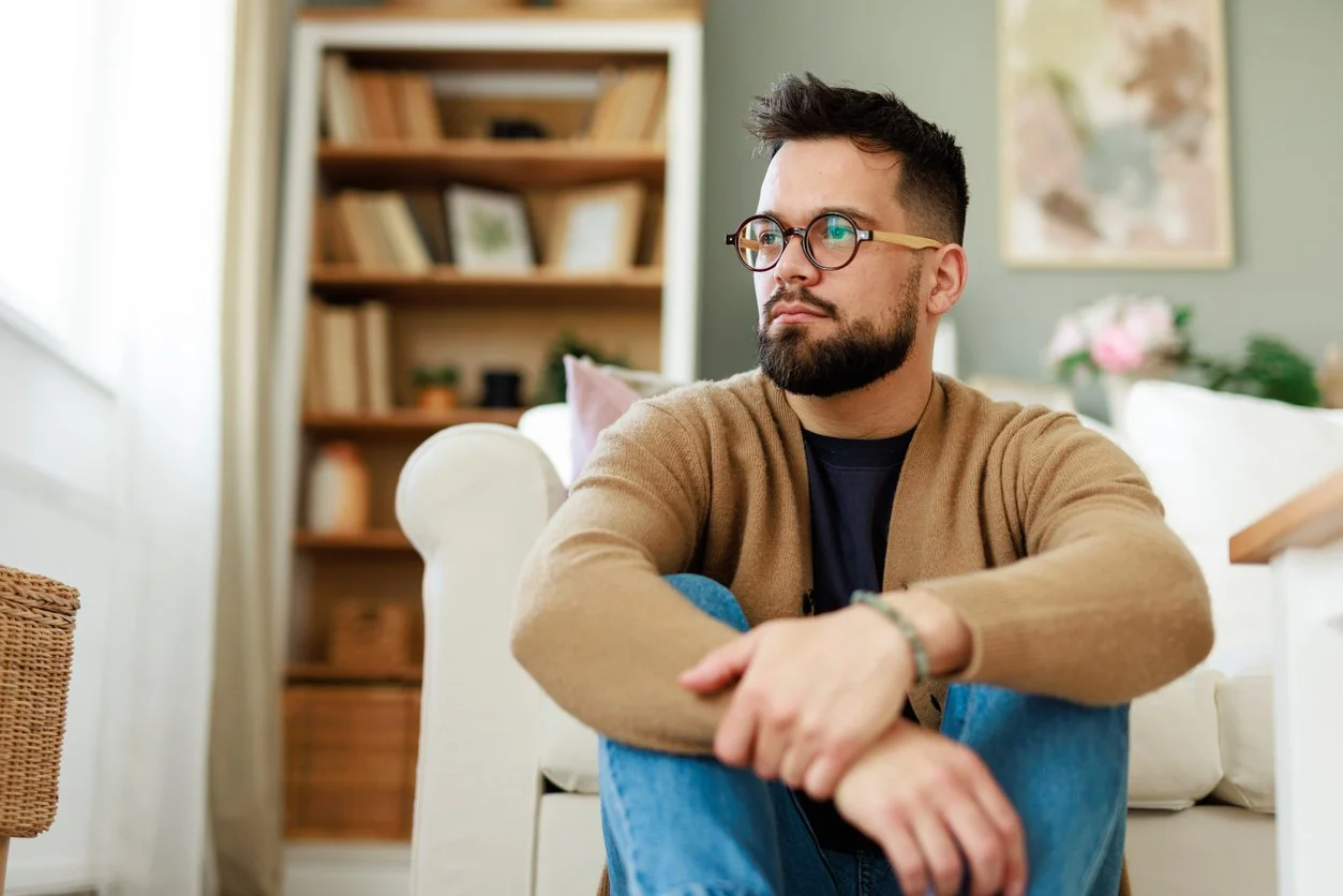 Man sitting in quiet reflection representing body image therapy for all bodies in NYC