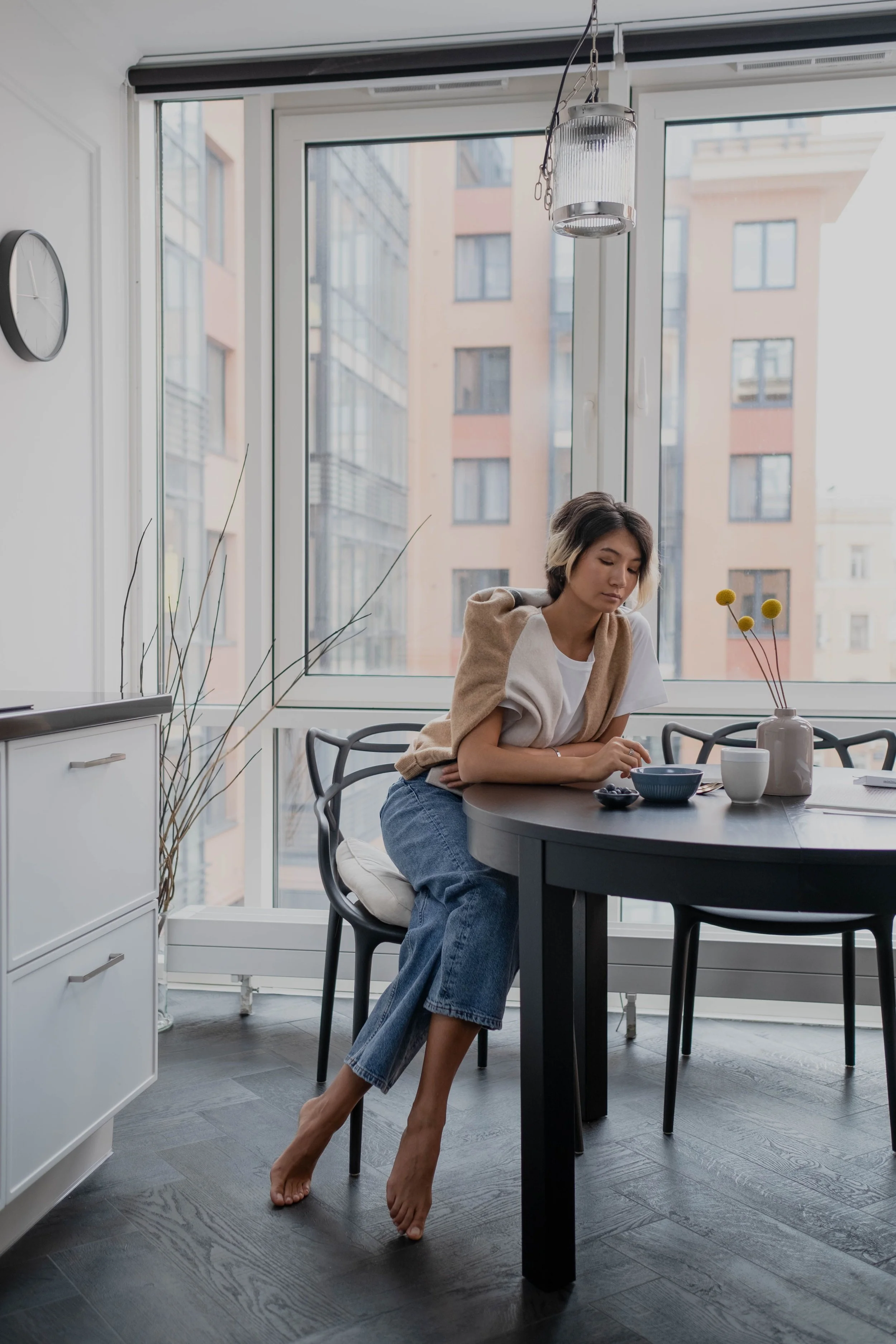 Woman at home with a city view, online OCD therapy in Hudson County New Jersey