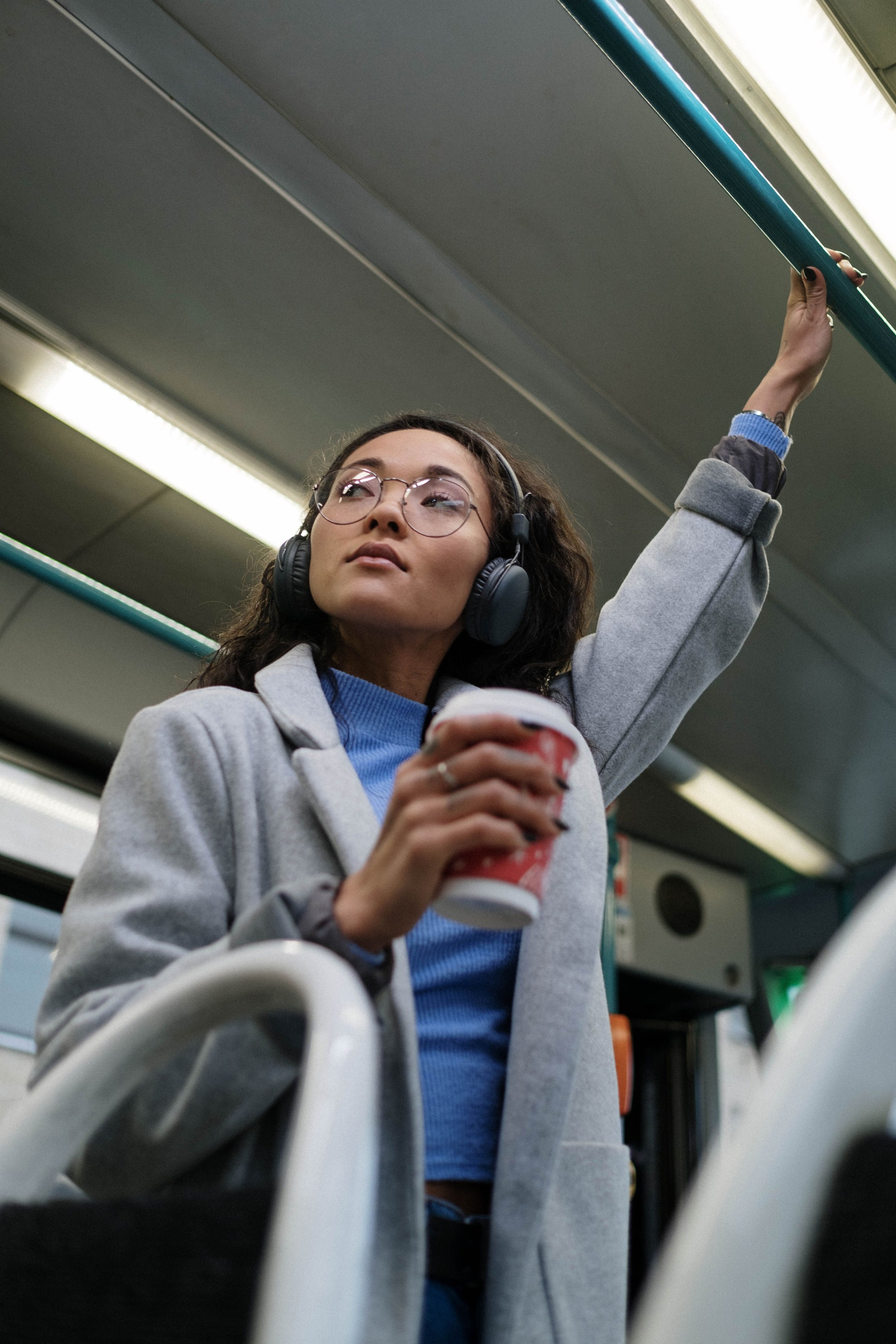 Woman commuting on NJ Transit with a coffee cup, OCD therapy for New Jersey commuters
