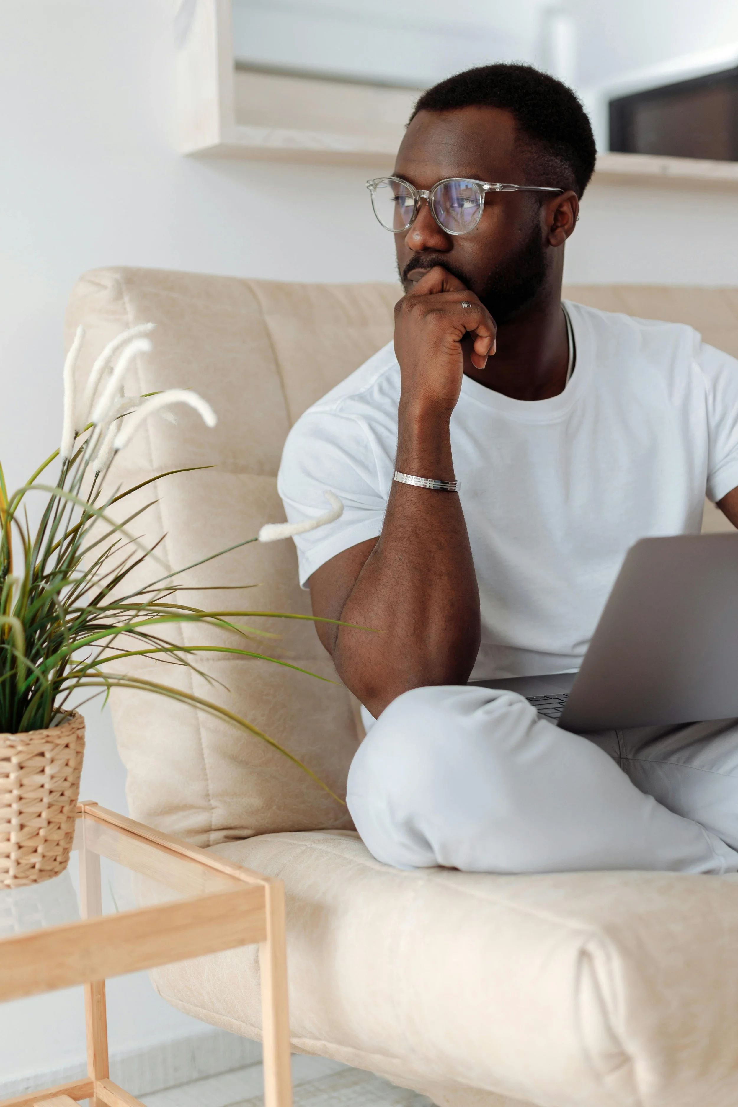 Man on his couch during an online OCD therapy session in New York