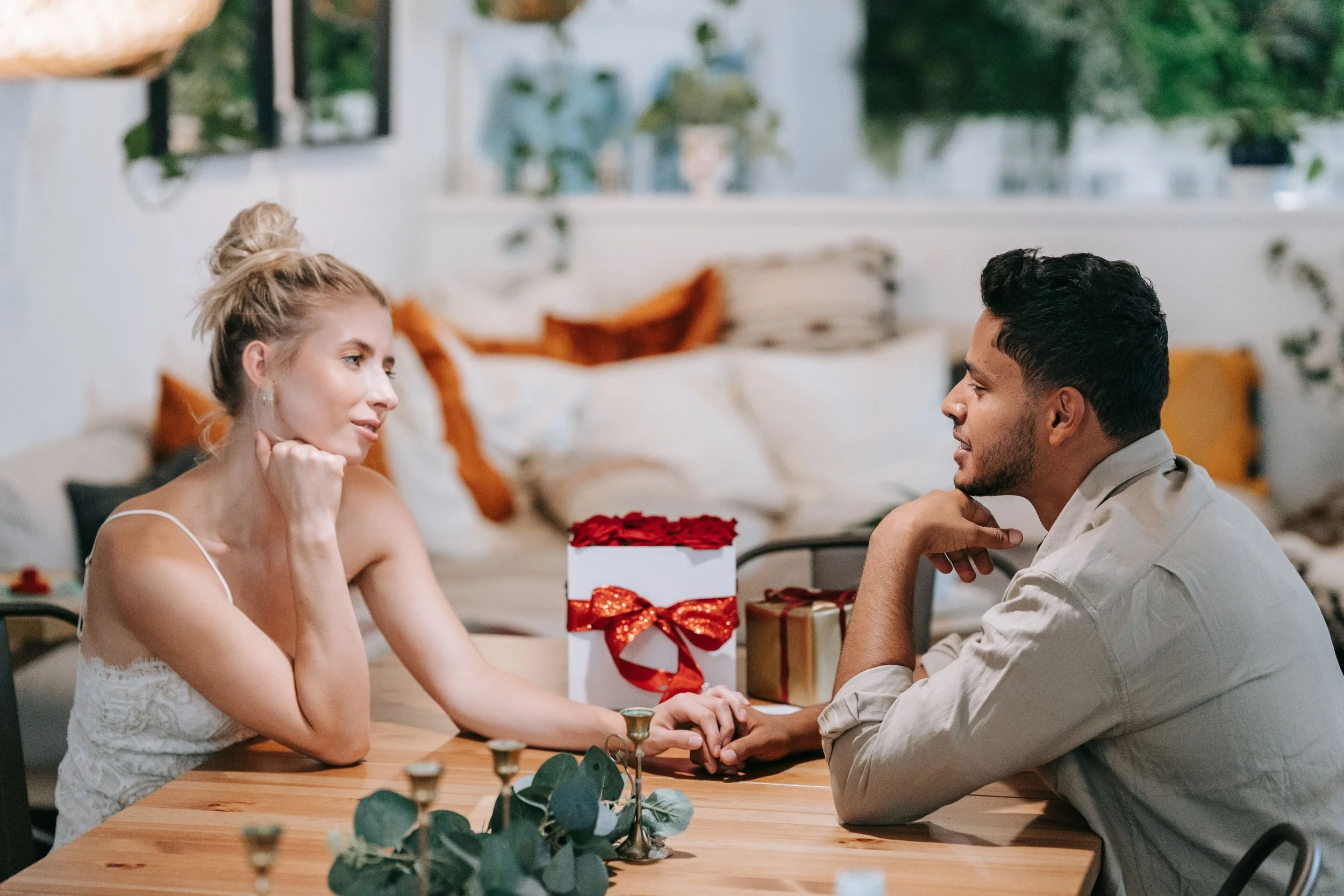 Woman sitting across from a partner at dinner, representing divided attention in body dysmorphic disorder