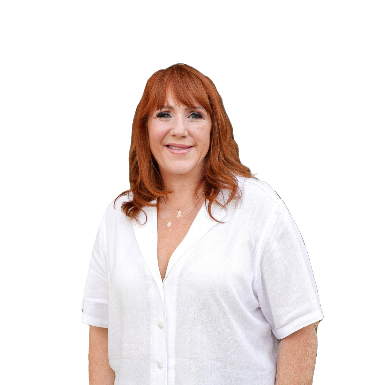 A woman with red hair wearing a white button-up shirt, smiling against a white background.