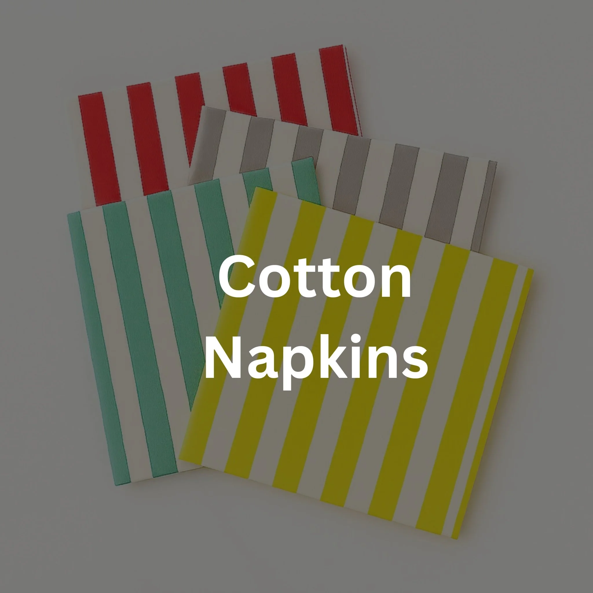 Three folded cotton napkins with colorful striped patterns in red, gray, turquoise, and yellow, arranged on a white surface.