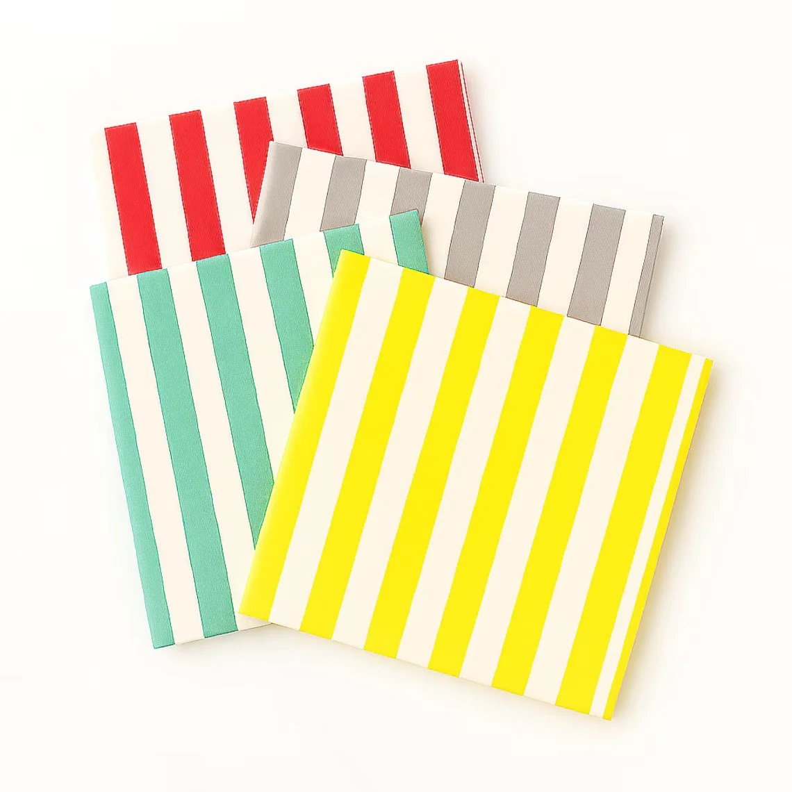 Four colorful striped paper bags, each with vertical stripes in different colors: red, gray, teal, and yellow, arranged on a white background.