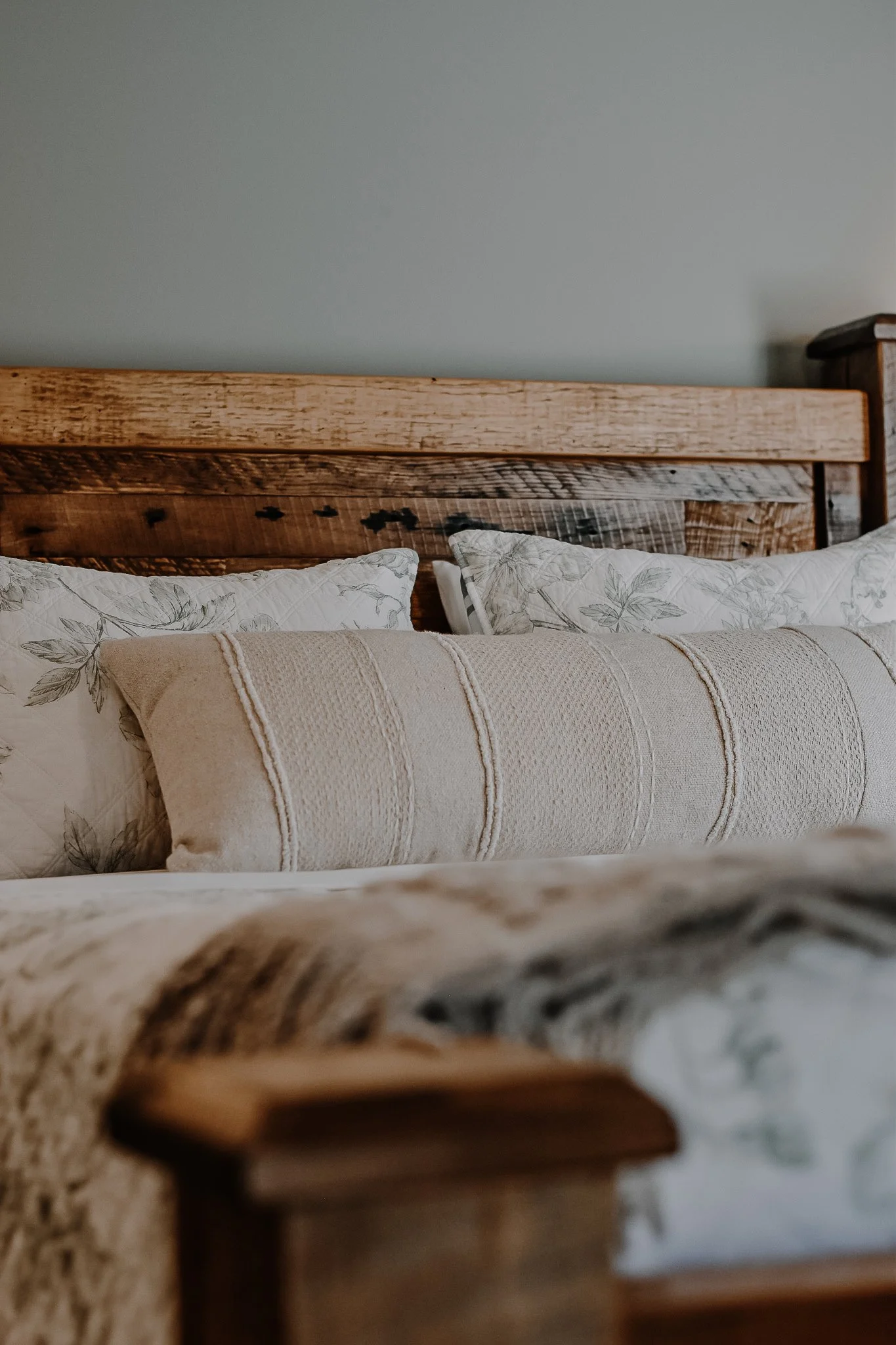 rustic modern farmhouse stay master bedroom wooden bedframe, creamy bed linens