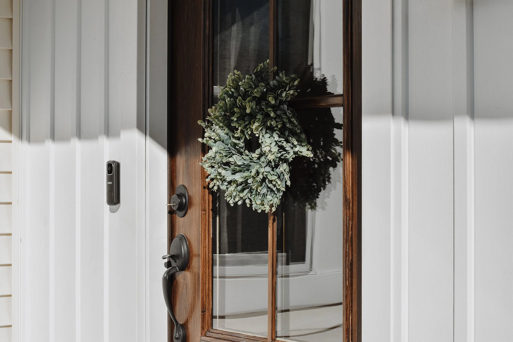 1890 restored farmhouse front door entrance with green wreath on glass door