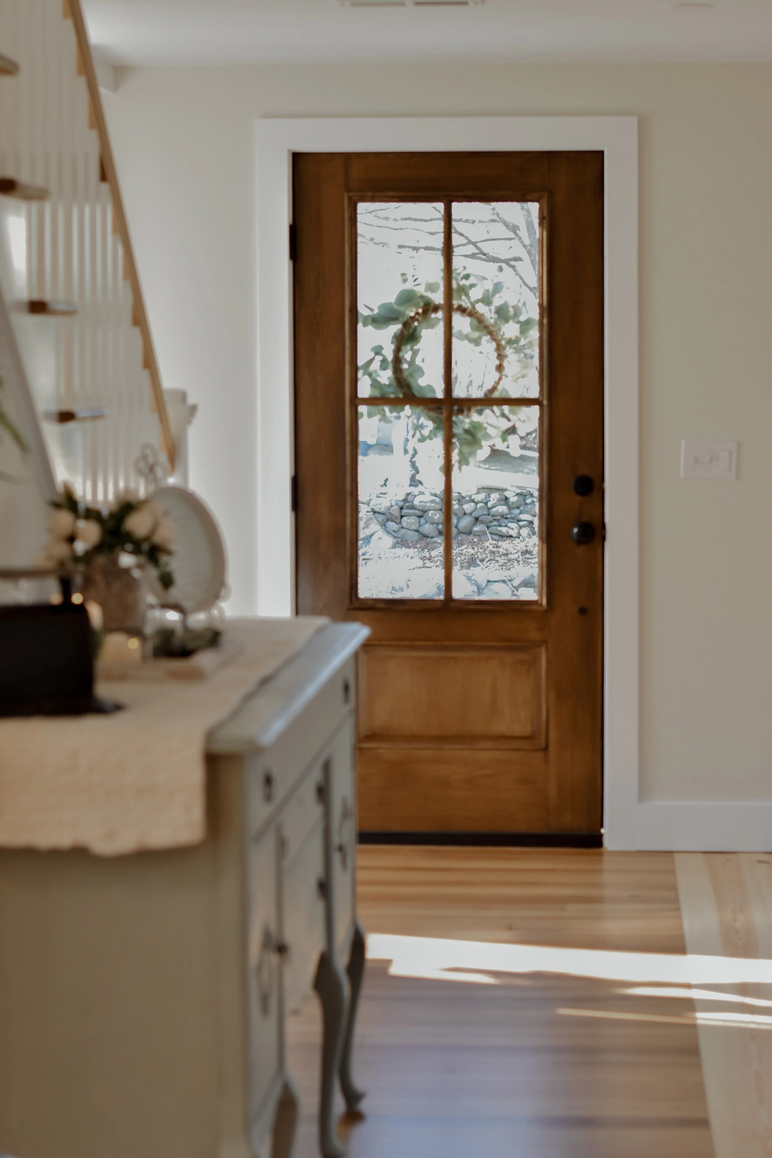 farmhouse natural light and front door and wood floors