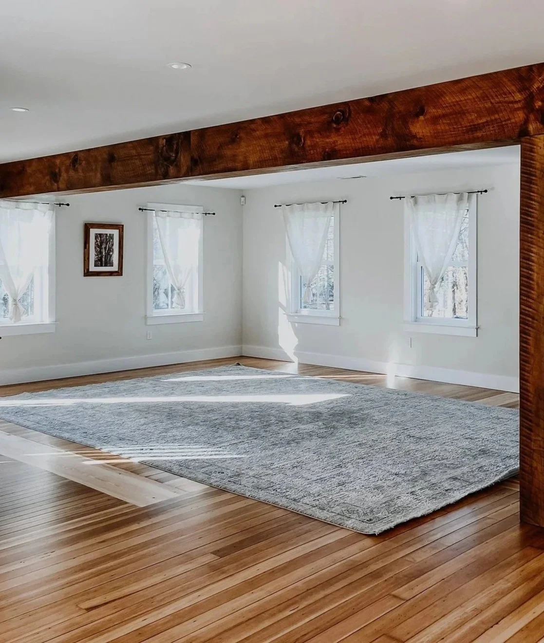 Restored 1890 Farmhouse dining room lined with Windows Natural Light pouring through linen curtains