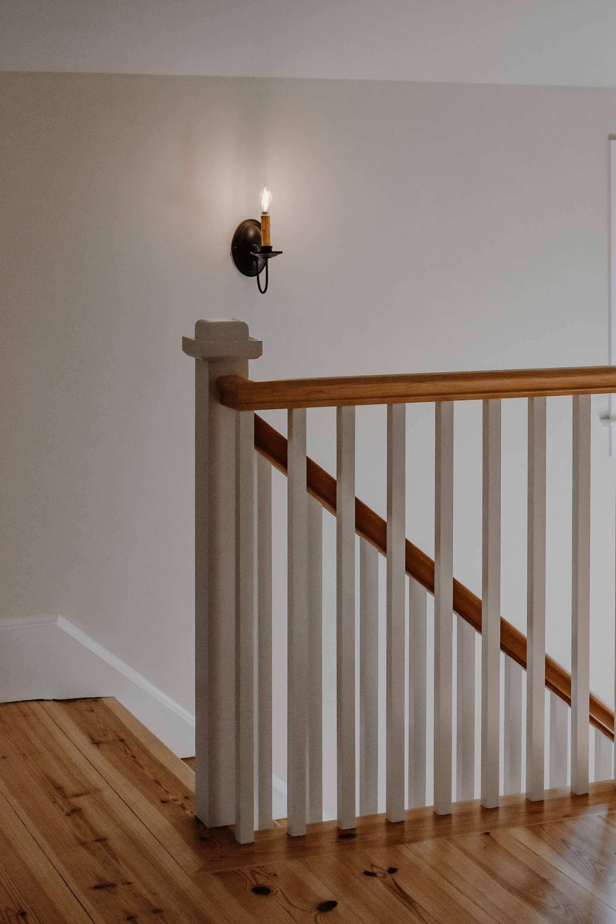 rustic modern farmhouse staircase view from upstairs, candlestick light fixture, refinished original 