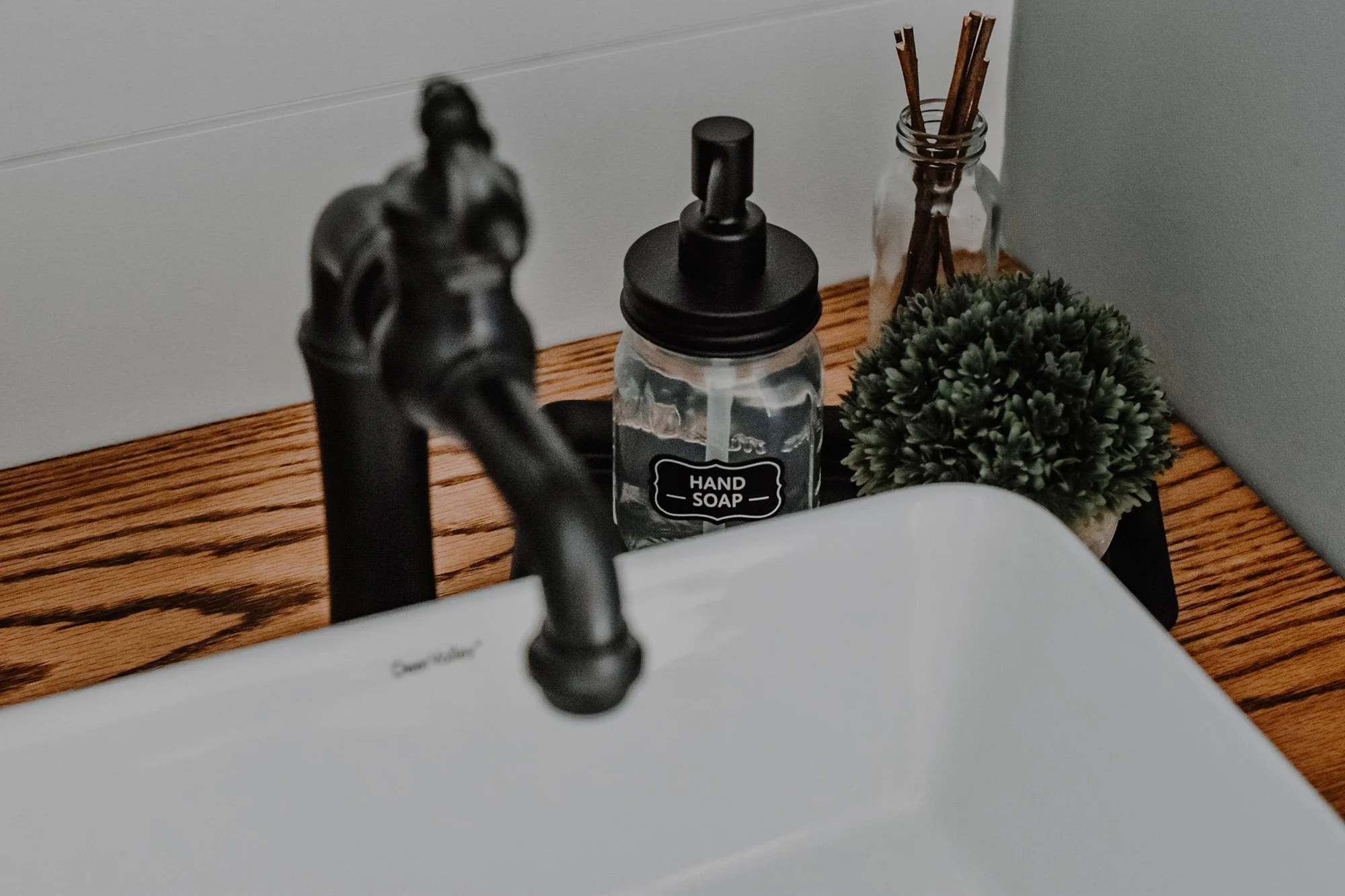 rustic modern farmhouse bathroom sink, refurbished undersink cabinet, farmhouse sink, industrial sink fixture, rustic farmhouse hand sap, small plant