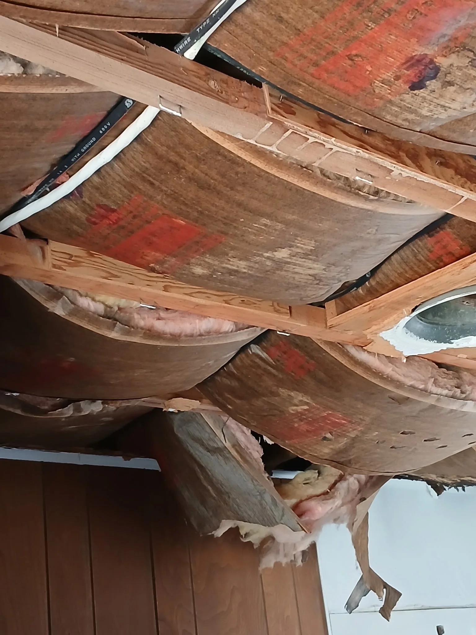 Construction framing with wooden beams and insulation material.